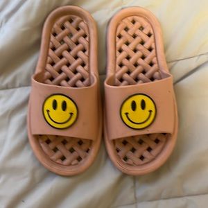 pink, yellow, and black smiley face slides